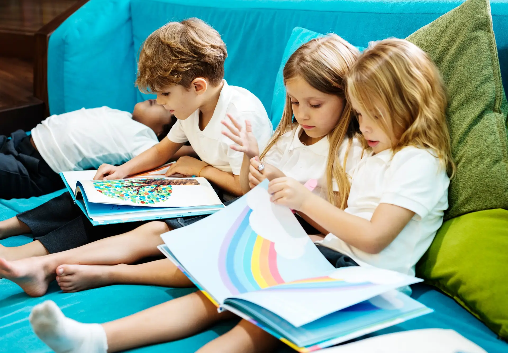 Group of Diverse Young Students Reading Children Story Book Toge